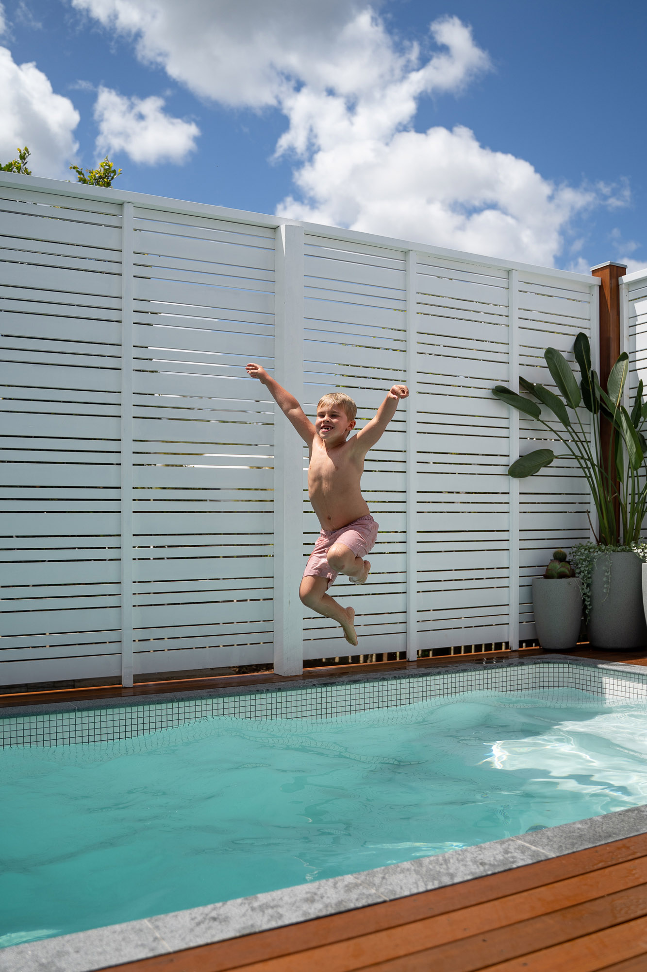 Young boy jumping into Plungie Studio 12ft x 7ft plunge pool in Kona Coast