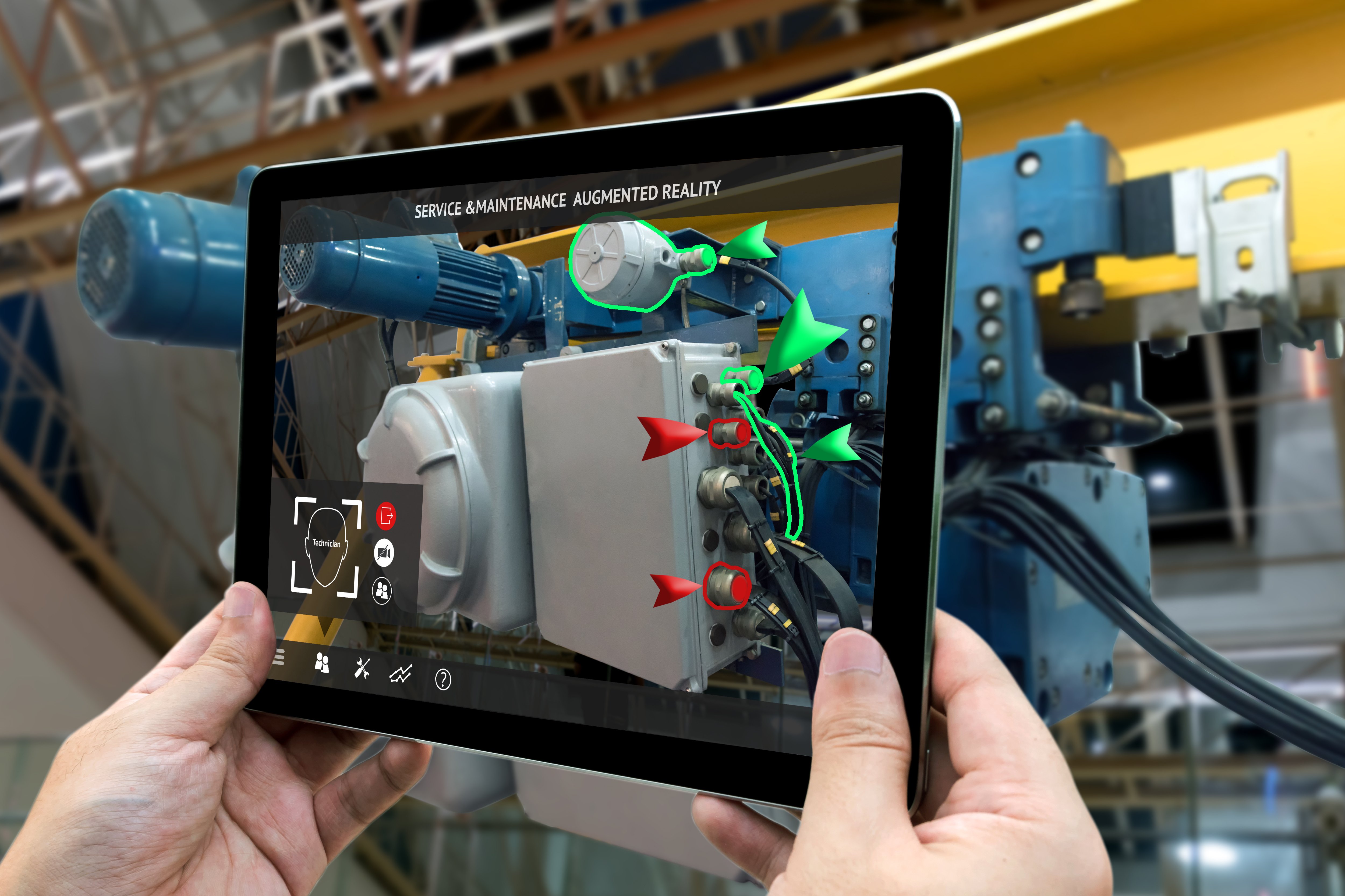 Factory worker uses predictive maintenance software on a tablet