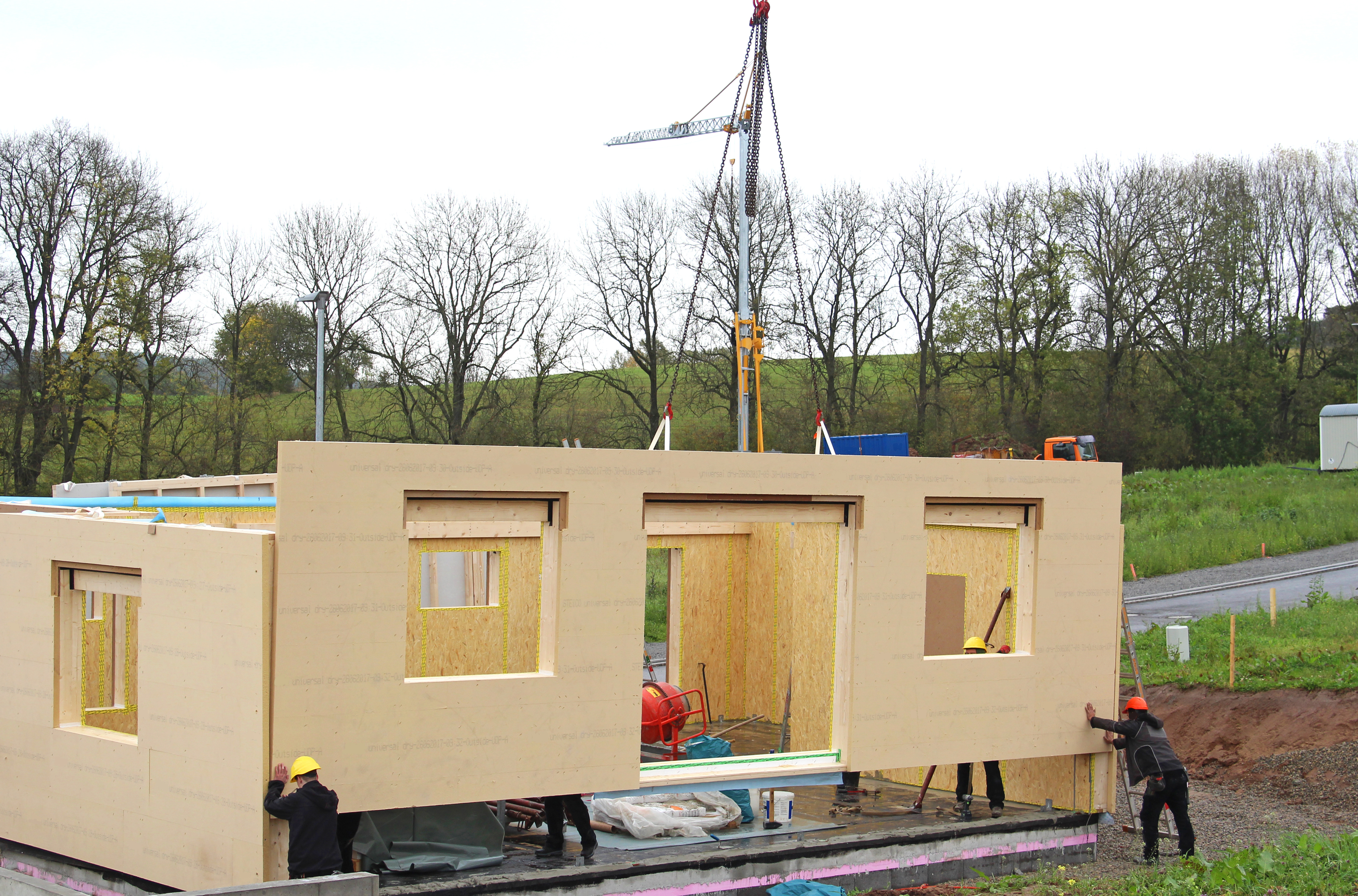 A construction team assembles a panelized prefab home